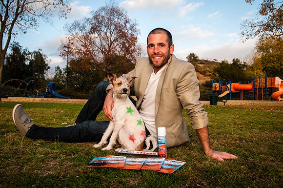 Abe Geary with his dog Monkey. Geary, who started a line of paints and stencils to use on dogs, turned down an equity offer on the hit ABC reality television show “Shark Tank” in favor of a startup loan from the Economic Development Collaborative. (photo by Thomas Wasper)