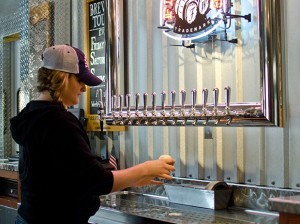 A server pours beer at Firestone Walker Brewing Co.’s Paso Robles campus, where the firm is building out more production space to gear up for more bottling. (Alex Drysdale / Business Times photo)