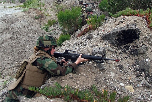 Builder Jennifer Moore, assigned to Naval Mobile Construction Battalion 4, takes cover while on patrol during a command post exercise at Naval Base Ventura County in a photo from 2009. Ventura County leaders are preparing to lobby intensely should the base be targeted in future defense spending cuts. (U.S. Navy courtesy photo by Master Chief Utilitiesman Alfa Lampman)