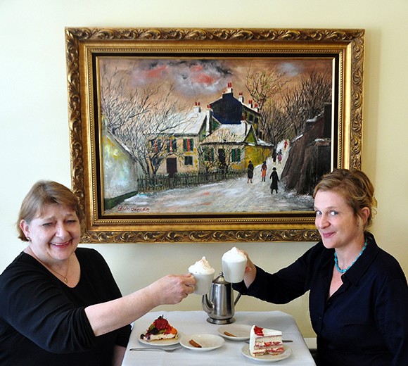 Birte, left, and Charlotte Andersen are the mother-daughter duo behind Andersen’s Danish Restaurant and Bakery in Santa Barbara. The business was started by Birte and her late husband Alfred in 1976 and is now a downtown landmark. The painting is by Alfred. (Wendy Jensen / courtesy photo)