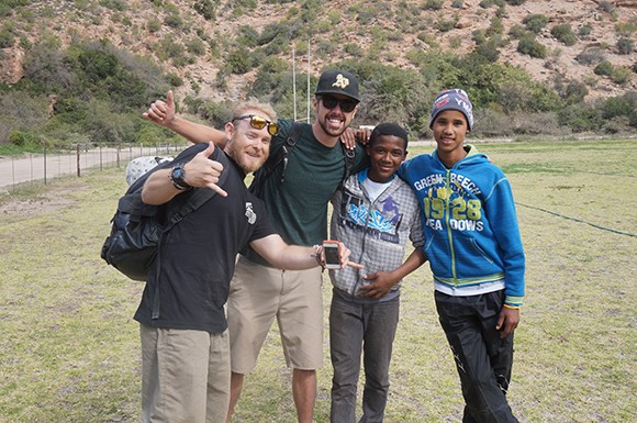 Swings for Dreams co-founders Mike Aguas and Nick Tuttle with two kids from the Ratang Bana Orphanage in Alexandra Township, South Africa. (courtesy photo)