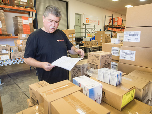 Direct Relief International warehouse operator Henry Rodriquez gathers medical supplies to be shipped to various clients. (Nik Blaskovich / Business Times photo)
