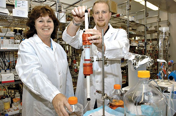 Amgen scientists Nessa Hawkins, left, and Robert Kurzeja pose in the company's lab in Thousand Oaks. (Bloomberg News file photo)