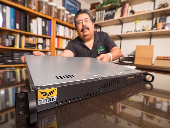 George Baldonado of Oasis Technology with the company’s Titan anti-hacking device. (Nik Blaskovich photo)