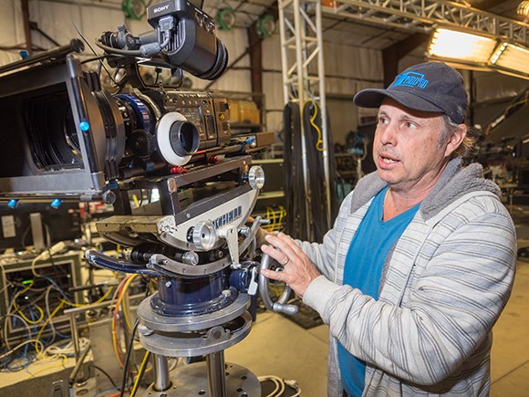 Todd Fisher, CEO of Hollywood Motion Picture Experience, standing next to their camera equipment set up in Studio 32. (Nik Blaskovich / Business Times photo)