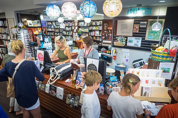 Book Buyer Vanessa Arizmendi, left, and Children’s Coordinator Ellen Jue ring up customer purchases at Granada Books. (Nik Blaskovich / Business Times photo)