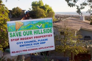 "Save Our Hillside" signs line the neighborhood on Hillcrest Drive, situated just below the proposed development.