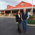 Incoming CEO Cara Crye and retiring CEO Jim Brabeck pose outside the Farm Supply Company store in San Luis Obispo. (Courtesy photo)